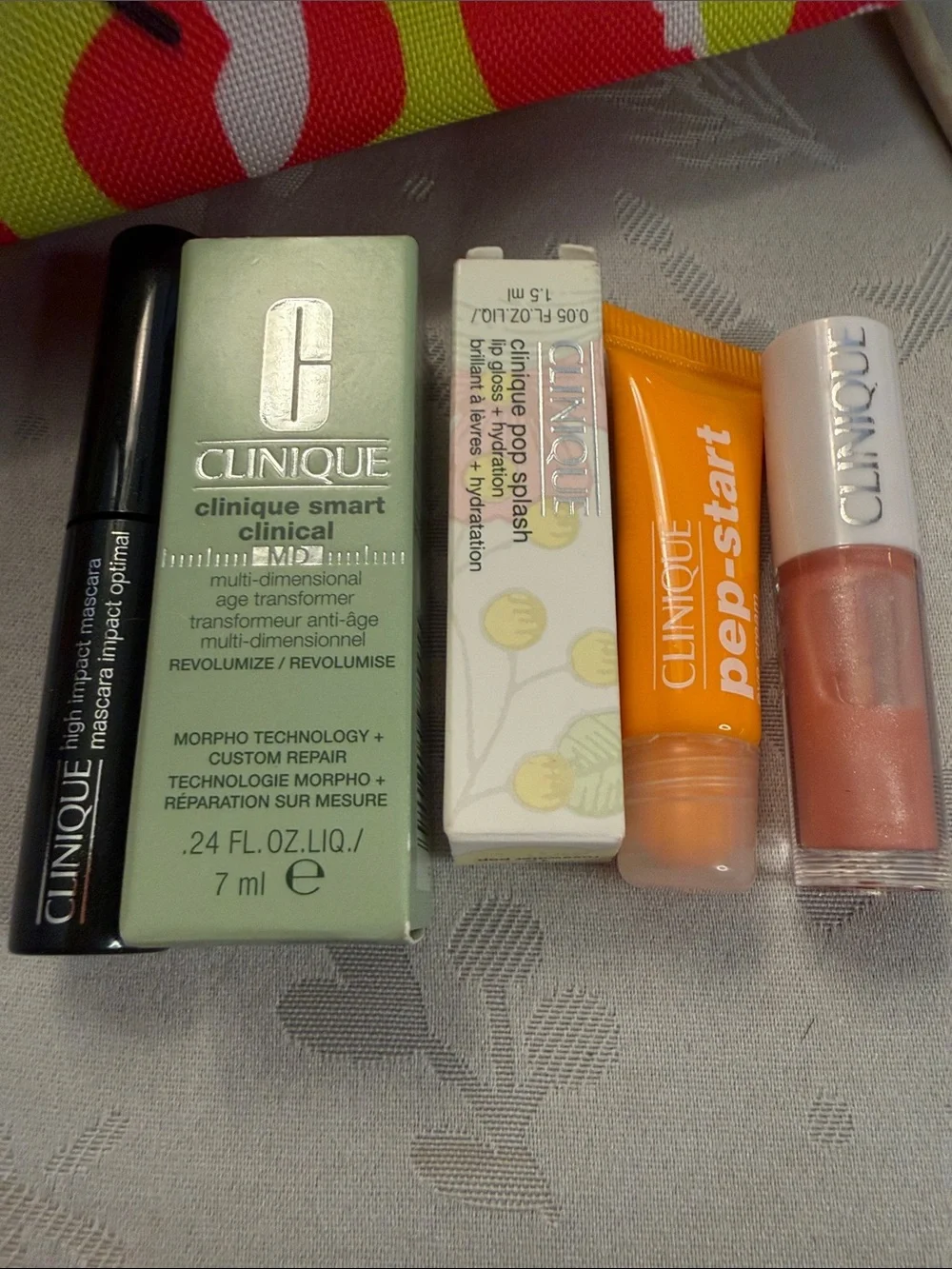 Clinique Yellow Cosmetic Pouch with Red Apple Print and Lip Balms